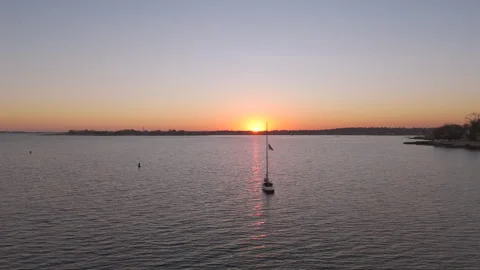 4k drone sailboat docked during sunset, camera moving left to right Stock Footage 290919756