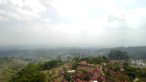 4K Drone Shot Ascending Forward Over Tropical Village and Valley Stock Footage 315229450