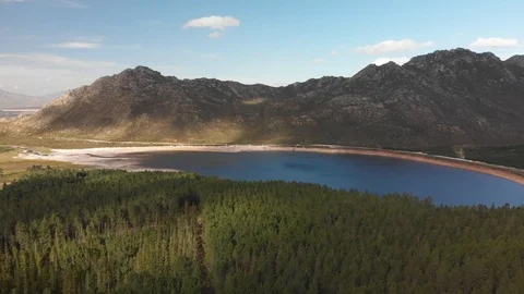 4k Drone Shot Flying Over Tree Tops Towards Small Dam Stock Footage 92946677