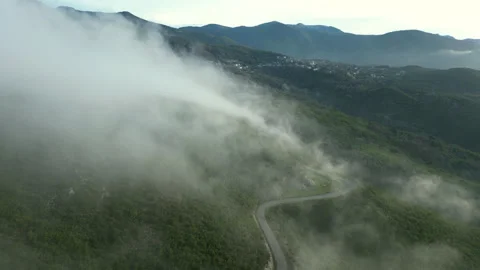 4k Drone shot Mountain road revealed after clouds Stock Footage 292643519