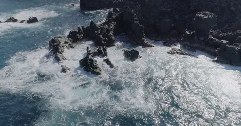 4k drone shot of oceanic beautiful waves crashing rocks Stock Footage 83873460