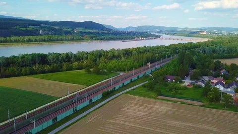 4k drone shot of passanger train in front of big river Stock Footage 108590440