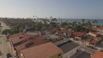 4K Drone shot of sunny, small town with the ocean in the background Stock Footage 85915541