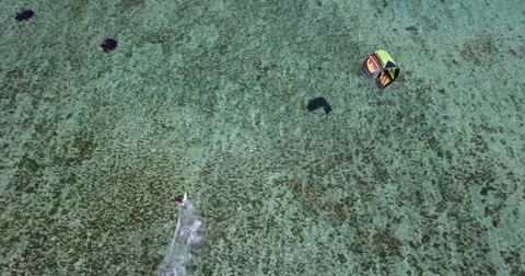 4K Drone Shot Tracking Kite Surfer over clear blue water in Mauritius Stock Footage 66696205