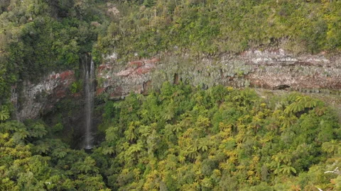 4K Drone Shot of Waterfall Dropping Over Red Cliffs Stock Footage 140026242
