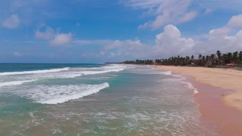 4K Drone Side Scrolling Shot of Ocean Waves Rolling Onto Sandy Shoreline Stock Footage 315465760