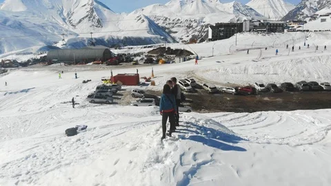 4k drone skyline view around 3 men in a sunny day in Alps, Georgia Stock Footage 112187060