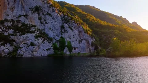 4K Drone Slide Over River at Sunset Revealing Ancient Royal Tombs Stock Footage 336546605
