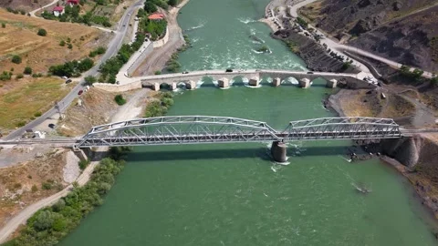 4K Drone Slow Descent Toward Railway and Historic Bridge Over River Stock Footage 336235043