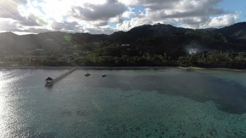 4K drone steady push-in shot of barrier coral reef and the forested coastline Video stock 94626255