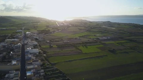 4k drone - Sunrise - Farm fields &amp; coastline at sunrise.  Island of Gozo, Malta Stock Footage 83019194