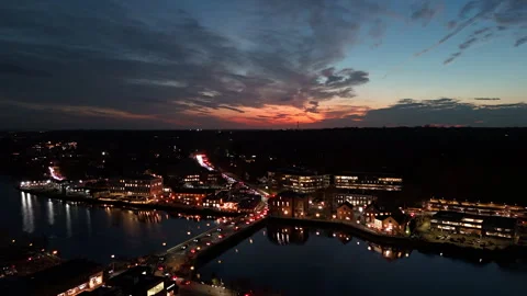 4k drone sunset timelapse over suburb split by river with cars going over bridge Stock Footage 290989888