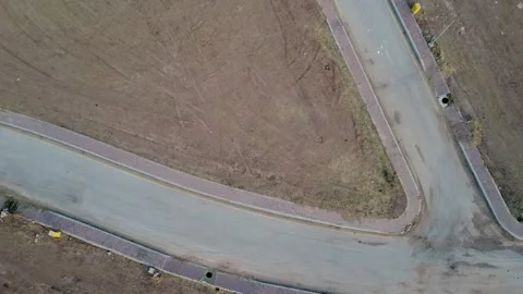 4K drone surveys a corner plot, showcasing real estate concepts. Stock Footage 302153941