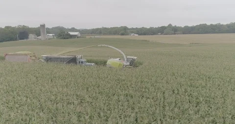 4K Drone Sweeping In Front of Crop Harvester during Farm Harvest Stock Footage 96702112