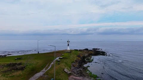 4K Drone Tilt-Down: Yason Burnu Lighthouse in Overcast Winter Sky Stock Footage 334338281