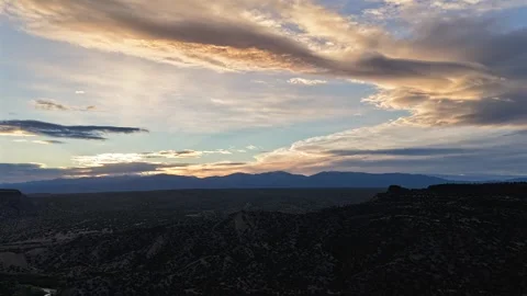 4K Drone Timelapse of Angled Cloud Patterns and Shimmering Sun over a Southwest Stock Footage 334690863