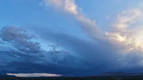 4K Drone Timelapse of Fast Moving Blue and White Cloud Blanket over a Mountain Stock Footage 335005399