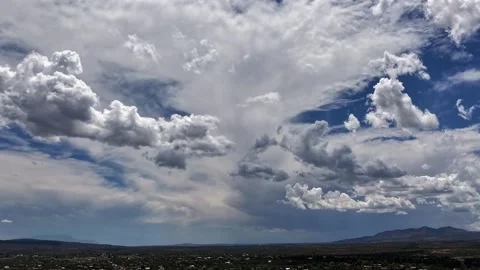 4K Drone Timelapse: Striking Dual Cloud Layers Sweeping Over Desert Town Stock Footage 339044545