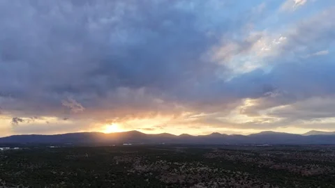 4K Drone Timelapse of the Sun Descending from Clouds to a Rugged Southwest 스톡 동영상 334648493