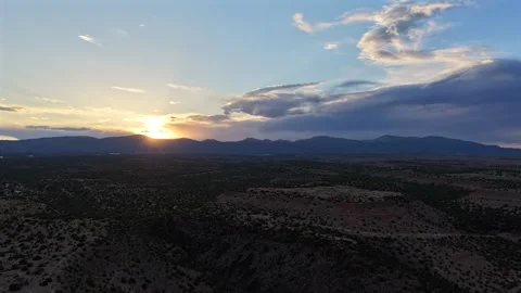 4K Drone Timelapse of Sunset behind Mountains with Dramatic Clouds over Desert Stock Footage 335921199