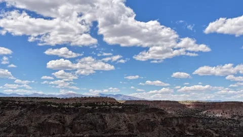 4K Drone Timelapse of Sweeping Dramatic Light and Clouds Over Rugged Desert Stock Footage 335921178