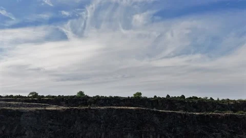 4K Drone Timelapse Tracking Clouds Moving Behind a Rugged Canyon Cliff Stock Footage 335008828