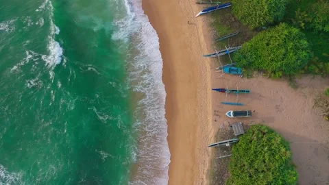 4K Drone Top Down Push In of Beach with Fishing Boats and Sea Waves Stock Footage 318550863