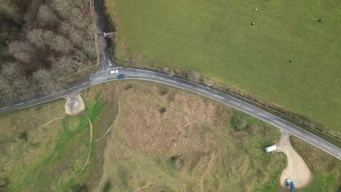 4K drone top down view of cars passing in an English country road Stock Footage 261617216