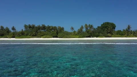 4K drone towards the sandy beach and palms of a Maldivian Island Видео 298050763