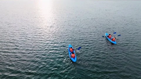 4K Drone Tracking Shot of Two Kayaks on Lagoon, Evening Light Stock Footage 316085216