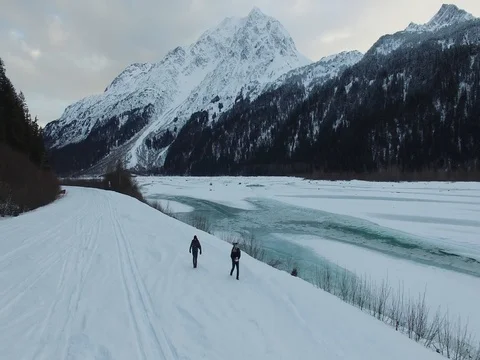 4K Drone | Two hikers walking through the snow, Alaska Stock Footage 81885015