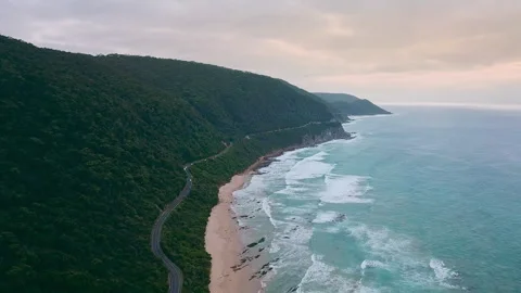 4K drone video of a camper van driving along a stunning long road next to a beau Stock Footage 294620566
