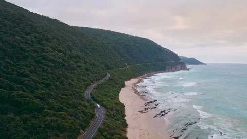 4K drone video of a camper van driving along a stunning long road next to a beau Stock Footage 294620651