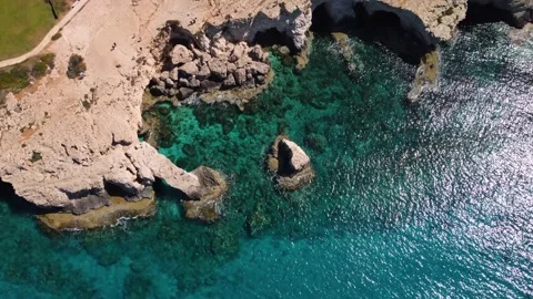 4K drone video of crystal clear water and rocky cliffs Stock Footage 237356653