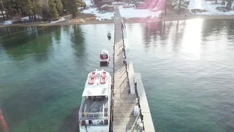 4K Drone video flyover dock green lake with snow Видео 143830506