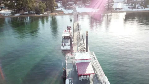 4K Drone video flyover over a boat ferry on a dock emerald lake Видео 143828951