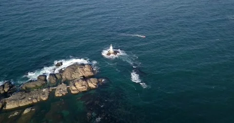 4K Drone video of lighthouse and boat in the sea Stock Footage 140810109