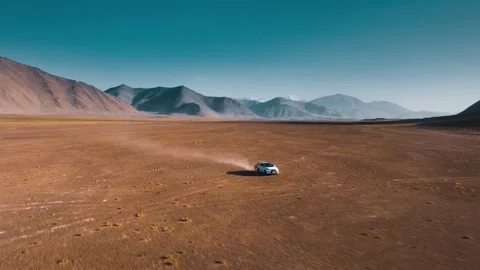 4K drone video recording a car in a mountainous area Stock Footage 276673882