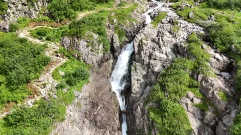 4K Drone Video Reversing From a Waterfall on a Mountainin Switzerland Stock Footage 283680687