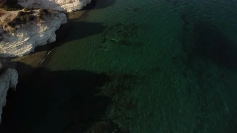 4K drone video of a sandy beach with white rocks at sunset Stock Footage 237341786