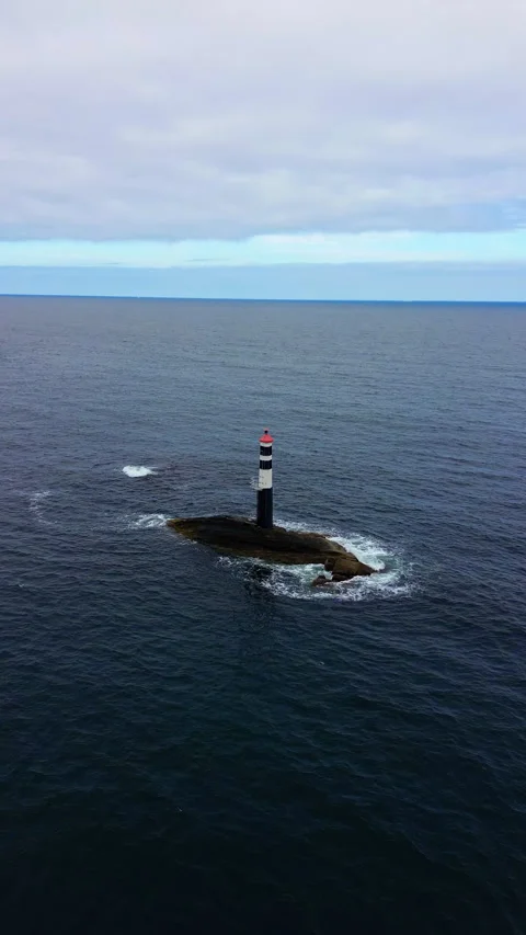 4K drone view of a lighthouse in the sea with deep blue water in Norway Stock Footage 296025978