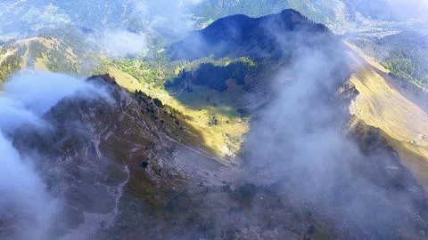 4K Drone View Misty Alpine Valley With Clouds And Sunlight Fotos de archivo
