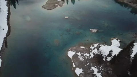 4K Drone View over Mountain lake in autumn, winter with snow and forest and way Stock Footage 90773276