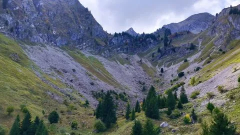 4K Drone View Rocky Alpine Valley With Forest And Cliffs Stock Photos