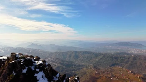 4K Drone View of Snowy Peak Above Coastal City and Blue Sea Stock-Footage 334921304