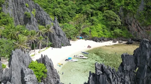 4K Drone view of tropical cliffy island with white beach and crystal clear water 動画素材 274061985