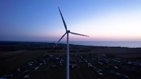 4K drone view of wind turbine at sunset by the sea Stock-Footage 317578380