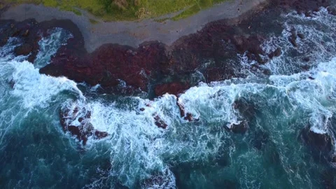 4K Drone Waves Breaking on Rugged Rocks at Dusk Stock Footage 331624566