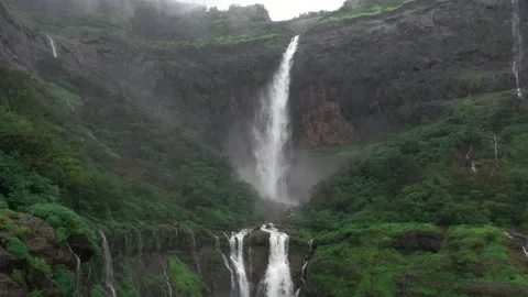 4K Drone's Descent: Aerial Slide Over the Waterfall Video stock 254057016