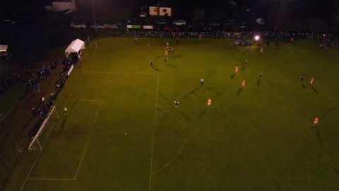 4K Droneview of players on the field during soccermatch with lots of visitors Stock Footage